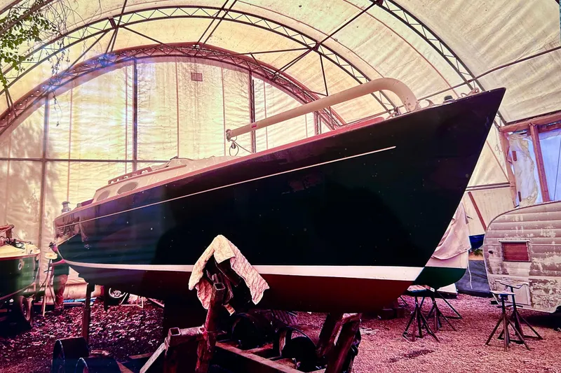 Slide: The Image of 2002 Alerion Express 28 sailboat in a covered storage area. - 2