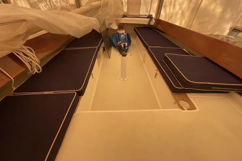 Slide: The Image of Interior of a 2002 Alerion Express 28 sailboat with navy cushions. - 20