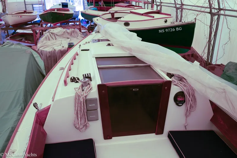 Slide: The Image of 2002 Alerion Express 28 sailboat in storage, surrounded by other boats. - 24