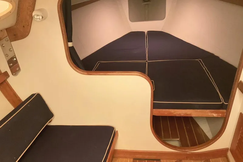 Slide: The Image of Interior cabin of 2002 Alerion Express 28 sailboat with blue cushions. - 28