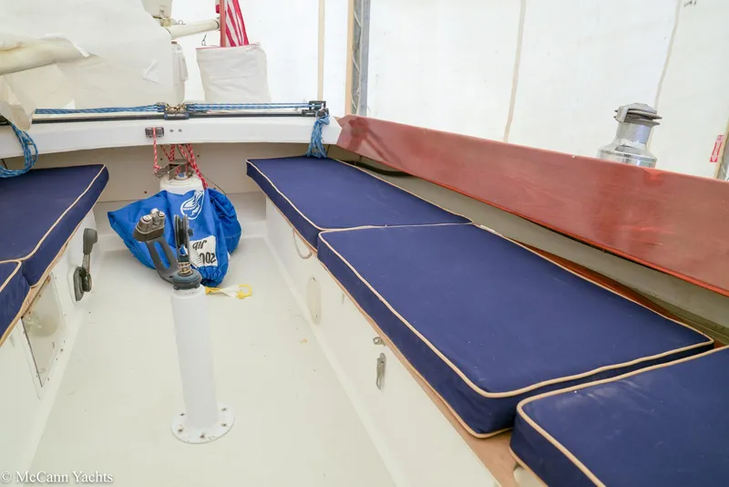 Slide: The Image of Interior of 2002 Alerion Express 28 sailboat with blue cushioned seating. - 3