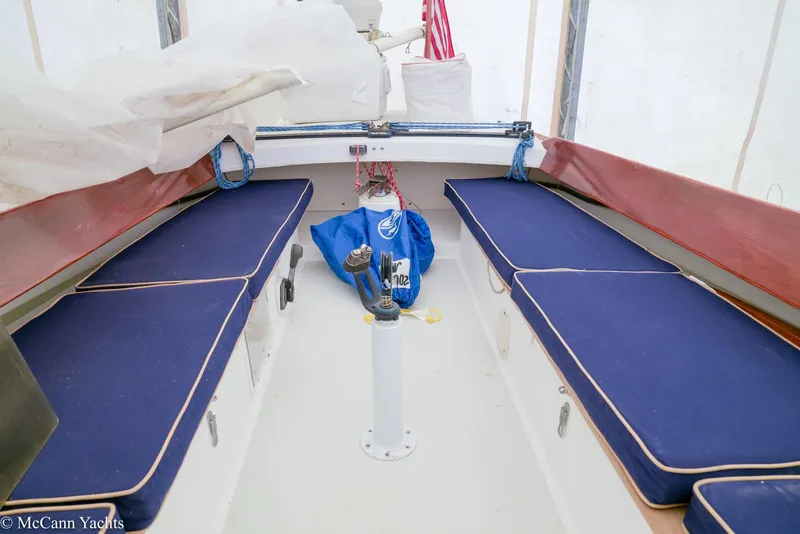 Slide: The Image of Interior of a 2002 Alerion Express 28 sailboat with blue cushioned seating. - 4