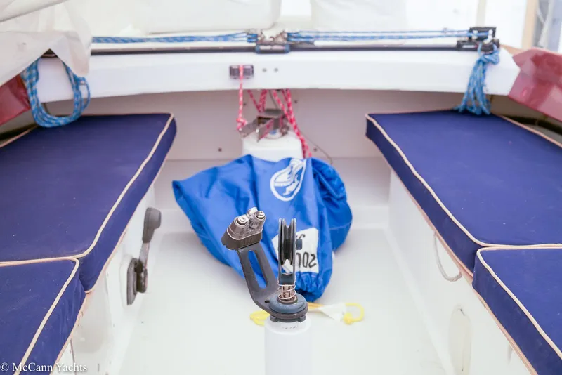 Slide: The Image of Interior of a 2002 Alerion Express 28 sailboat with blue seating and nautical equipment. - 5