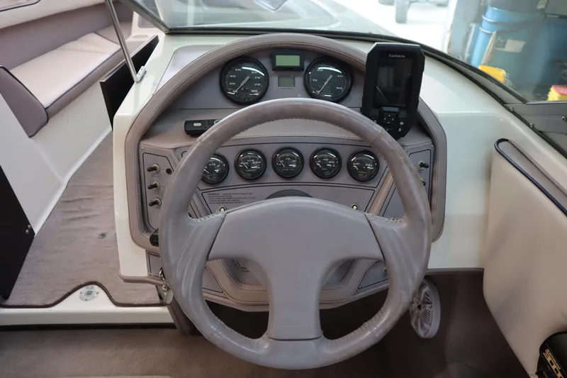 Slide: The Image of Steering wheel and dashboard of a 1996 Cobalt 220 boat, featuring gauges and controls. - 12