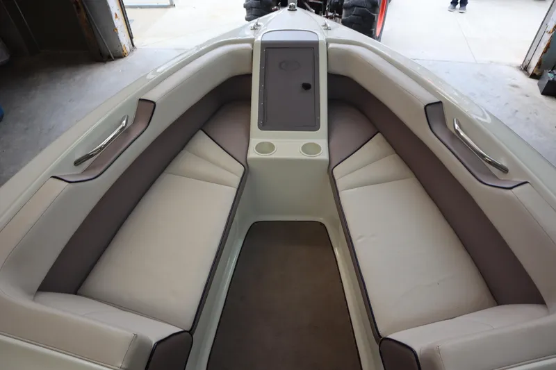 Slide: The Image of Interior of a 1996 Cobalt 220 boat with beige seating and storage compartment. - 18