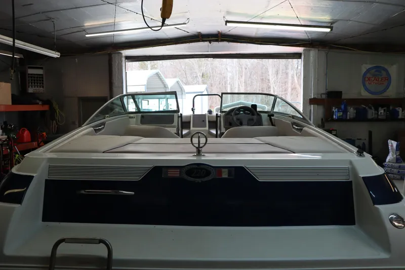 Slide: The Image of Cobalt 220 boat from 1996 in a garage, rear view with interior seating visible. - 22