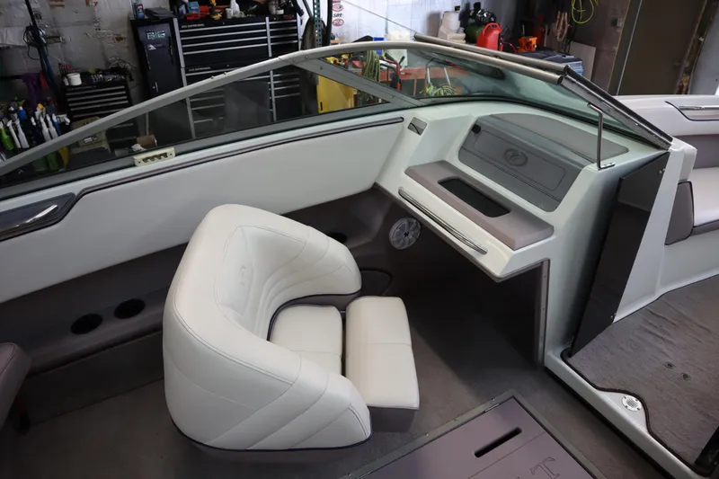 Slide: The Image of Interior of a 1996 Cobalt 220 boat with white seating and dashboard. - 8