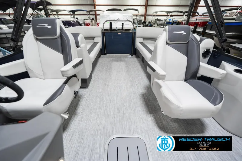 Slide: The Image of 2025 Bennington 22 SSR boat interior with gray and white seating, showcased at Reeder-Trausch Marine. - 17