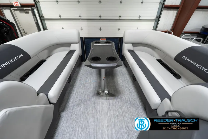 Slide: The Image of 2025 Bennington 22 SSR boat interior with gray seating and central table. - 21