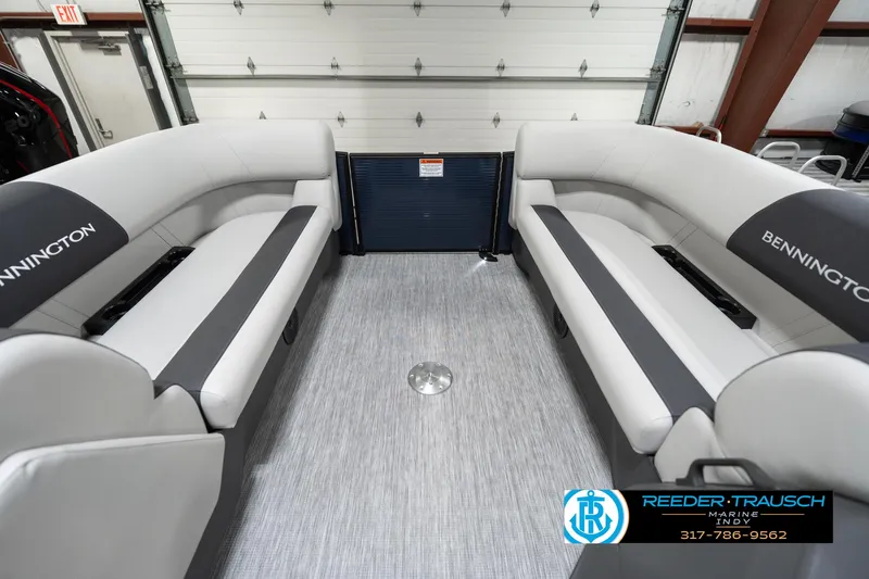 Slide: The Image of 2025 Bennington 22 SSR boat interior with gray seating and flooring in a garage setting. - 22