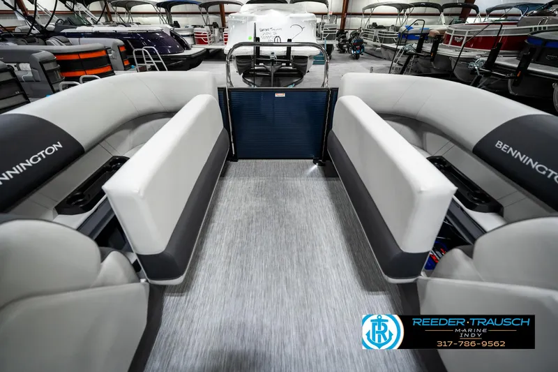 Slide: The Image of 2025 Bennington 22 SSR pontoon boat interior with gray seating and flooring in showroom. - 25