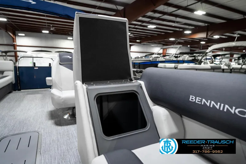 Slide: The Image of 2025 Bennington 22 SSR boat interior with open storage compartment in showroom. - 27