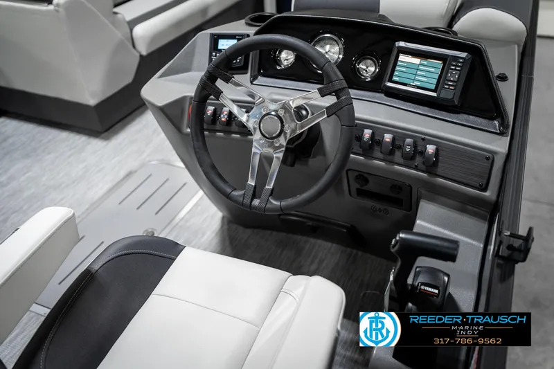 Slide: The Image of 2025 Bennington 22 SSR boat dashboard with steering wheel and control panel. - 28