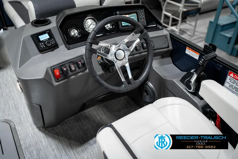 Slide: The Image of 2025 Bennington 22 SSR boat dashboard with steering wheel and control panel. - 29