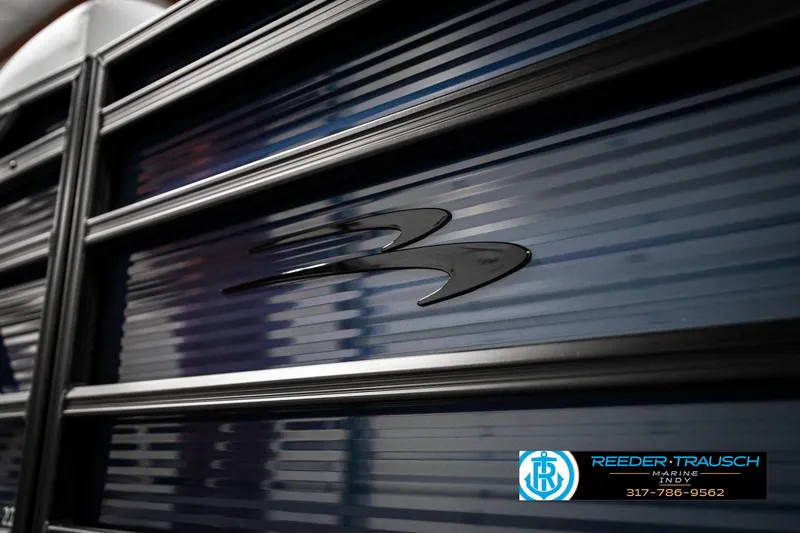 Slide: The Image of 2025 Bennington 22 SSR boat detail with sleek design and logo, Reeder-Trausch branding visible. - 44