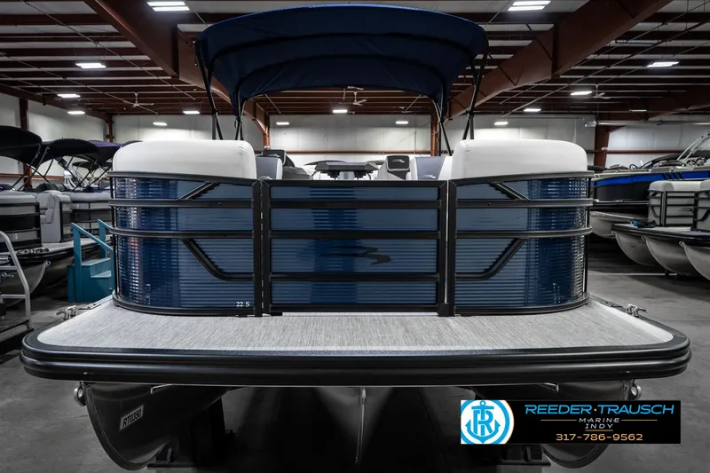Slide: The Image of 2025 Bennington 22 SSR pontoon boat in showroom, featuring sleek blue design and spacious deck. - 5