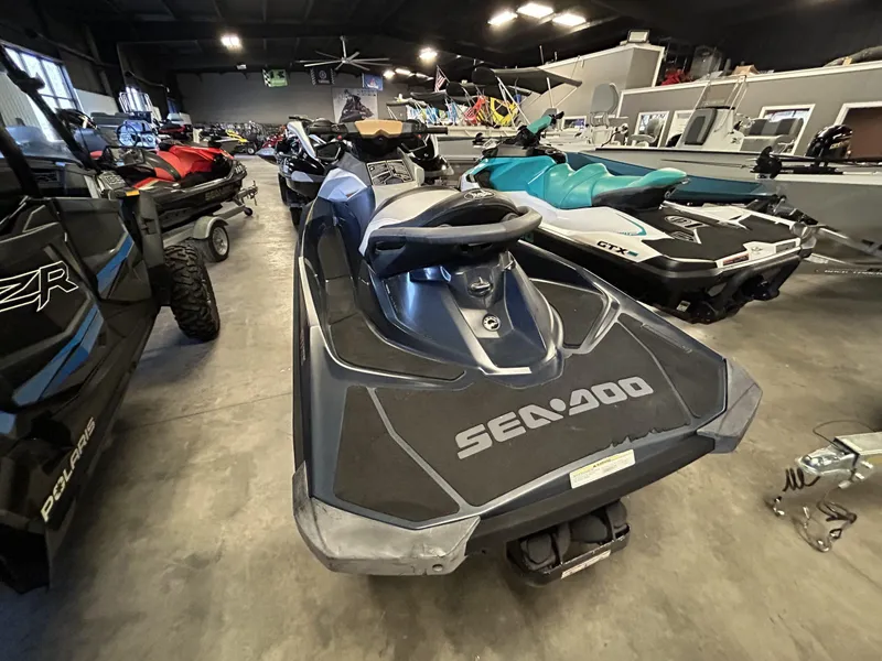 Slide: The Image of 2011 Sea-Doo GTI Limited 155 jet ski in showroom, surrounded by other watercraft. - 4