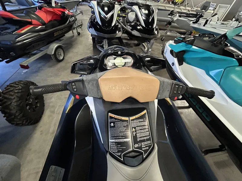 Slide: The Image of 2011 Sea-Doo GTI Limited 155 jet ski, dashboard view, in a showroom with other models. - 6