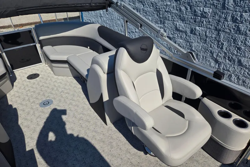 Slide: The Image of 2025 South Bay 224RS LE boat interior with plush seating and cup holders. - 5