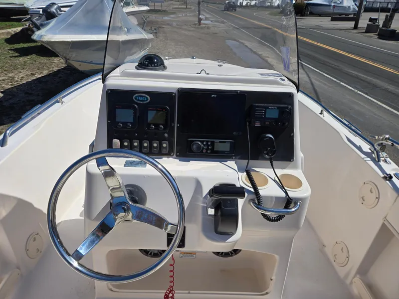 Slide: The Image of 2010 Grady-White Sportsman 180 boat console with steering wheel and navigation equipment. - 1