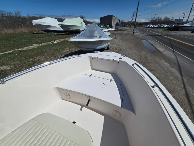 Slide: The Image of 2010 Grady-White Sportsman 180 boat on display, parked outdoors near a road. - 4