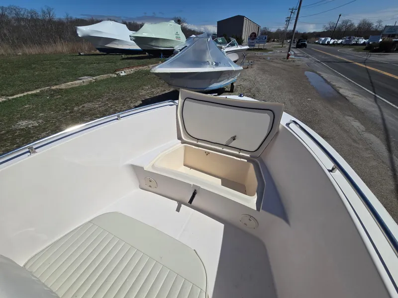 Slide: The Image of 2010 Grady-White Sportsman 180 boat with open storage compartment, parked outdoors. - 5