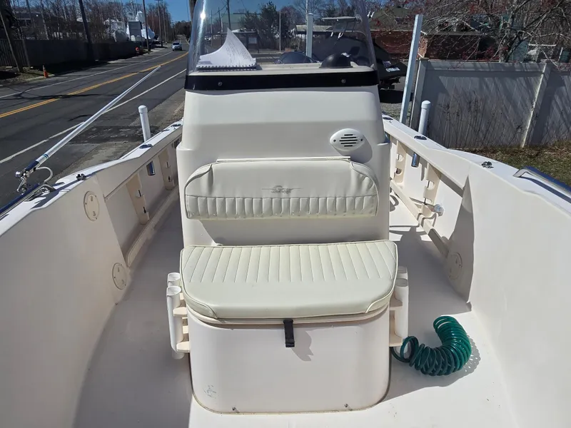 Slide: The Image of 2010 Grady-White Sportsman 180 boat interior with cushioned seating and console. - 8