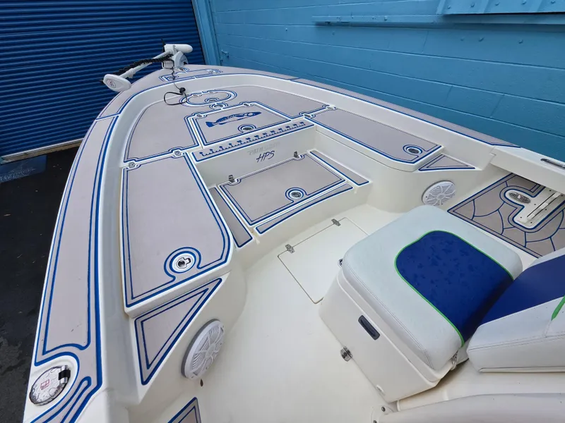 Slide: The Image of 2015 Pathfinder 2600 HPS boat deck with blue accents and seating, near blue wall. - 17