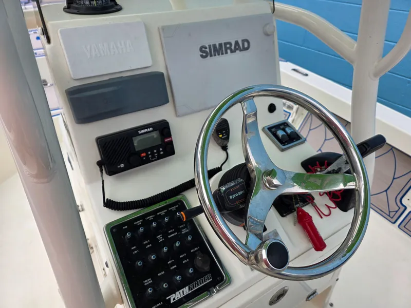 Slide: The Image of 2015 Pathfinder 2600 HPS boat console with Simrad electronics and steering wheel. - 18