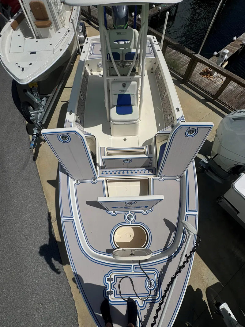 Slide: The Image of 2015 Pathfinder 2600 HPS boat with open deck and seating, docked at marina. - 20