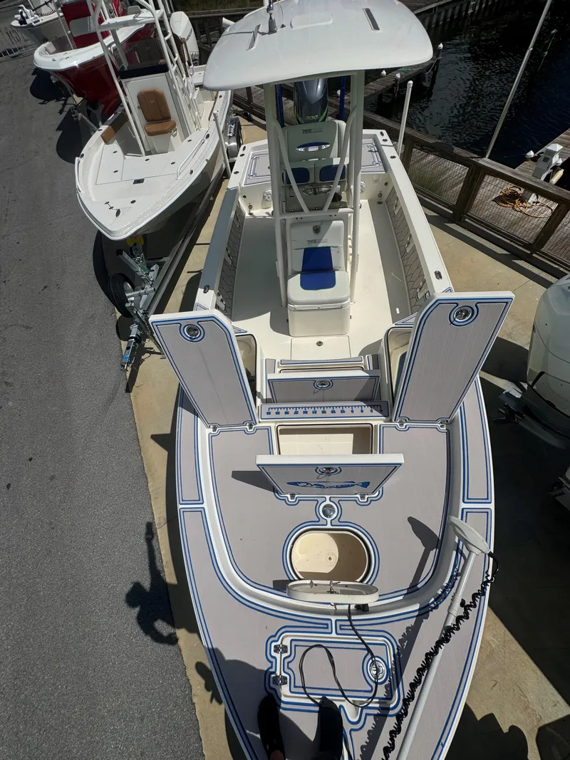 Slide: The Image of 2015 Pathfinder 2600 HPS boat docked, featuring a sleek design and spacious deck layout. - 21