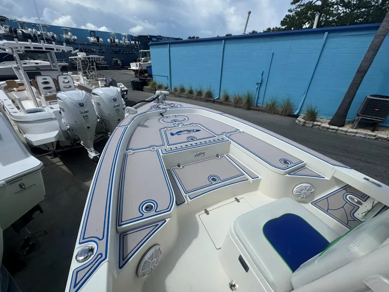 Slide: The Image of 2015 Pathfinder 2600 HPS boat with custom deck, docked alongside other vessels. - 23