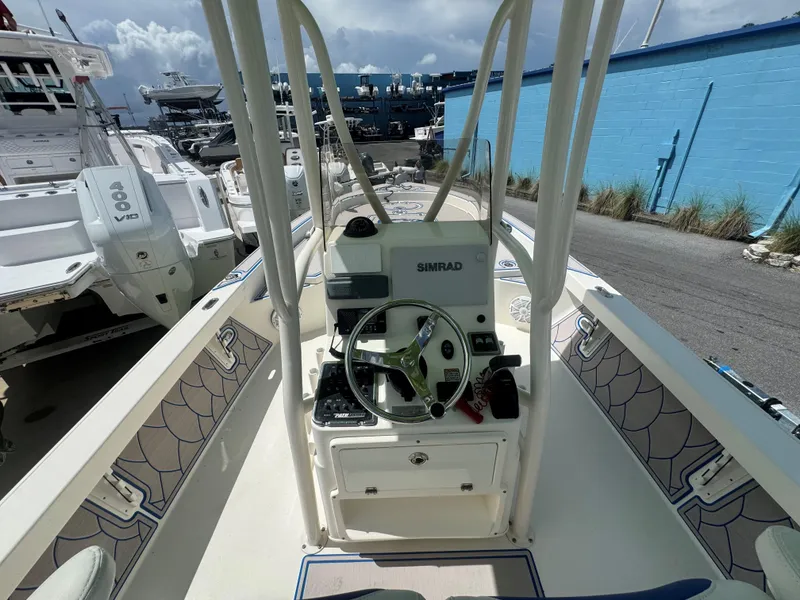 Slide: The Image of 2015 Pathfinder 2600 HPS boat interior with steering console and Simrad navigation system. - 25