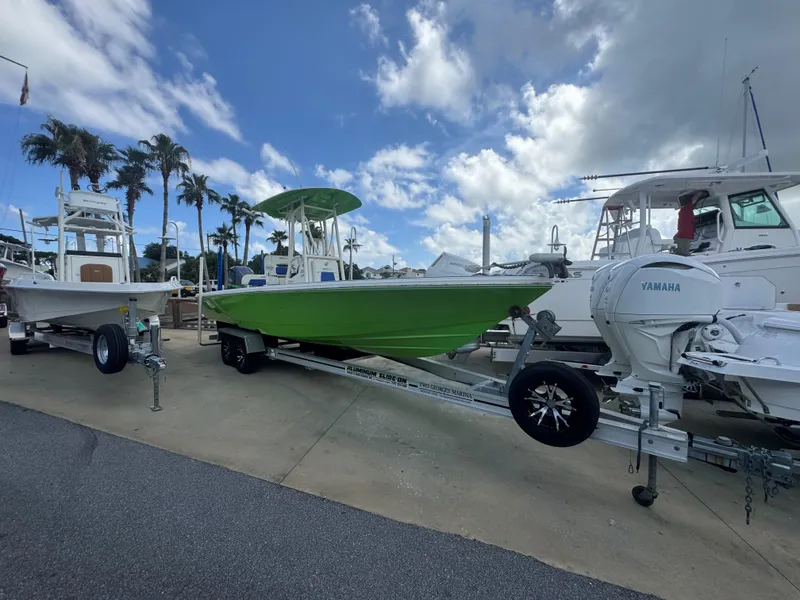 Slide: The Image of 2015 Pathfinder 2600 HPS boat on trailer, vibrant green hull, parked at marina. - 6