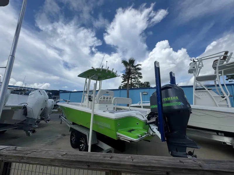 Slide: The Image of 2015 Pathfinder 2600 HPS boat with Yamaha engine, parked outdoors under cloudy sky. - 7