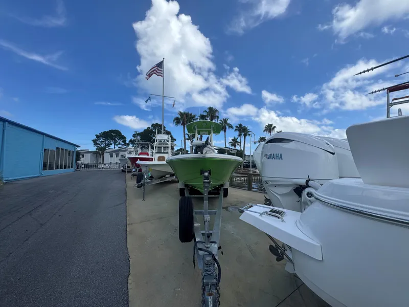 Slide: The Image of 2015 Pathfinder 2600 HPS boat in marina, clear sky, American flag, palm trees. - 8