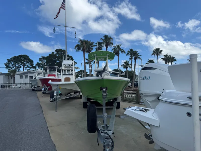 Slide: The Image of Boats on display, including a 2015 Pathfinder 2600 HPS, under a clear blue sky. - 9