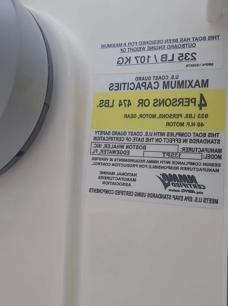 Slide: The Image of Capacity label on 2025 Boston Whaler 130 Super Sport, showing weight and passenger limits. - 11