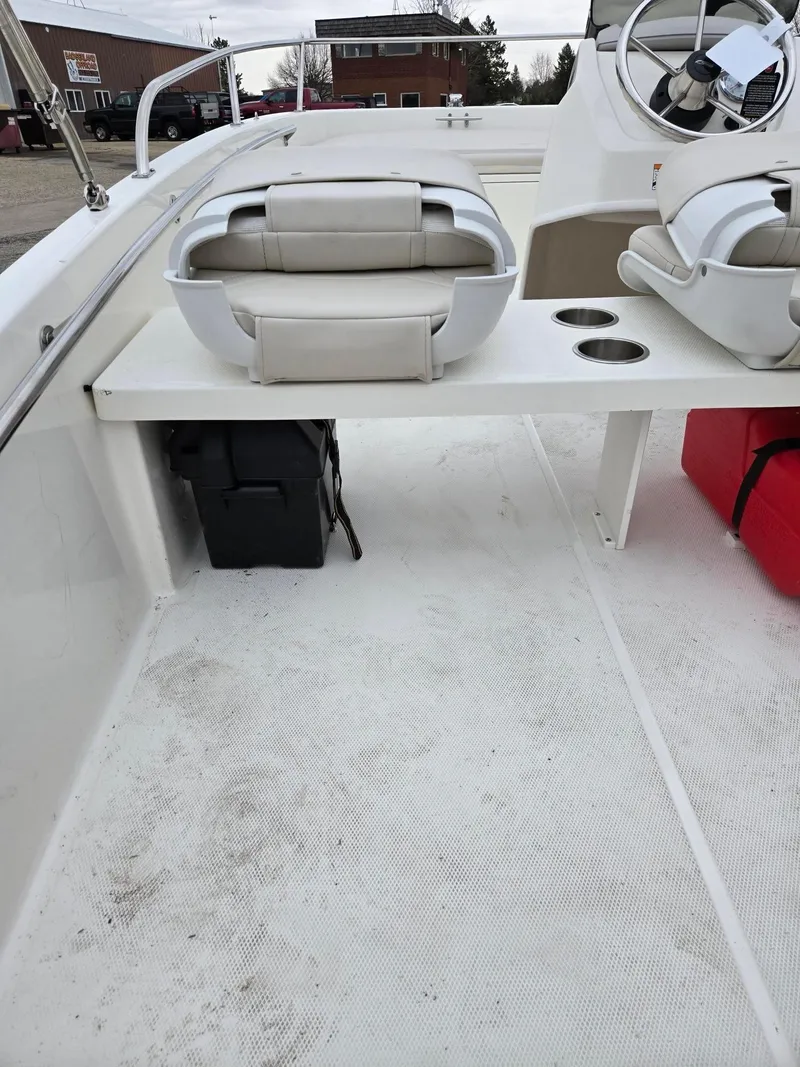 Slide: The Image of 2025 Boston Whaler 130 Super Sport interior with seating and steering wheel. - 4