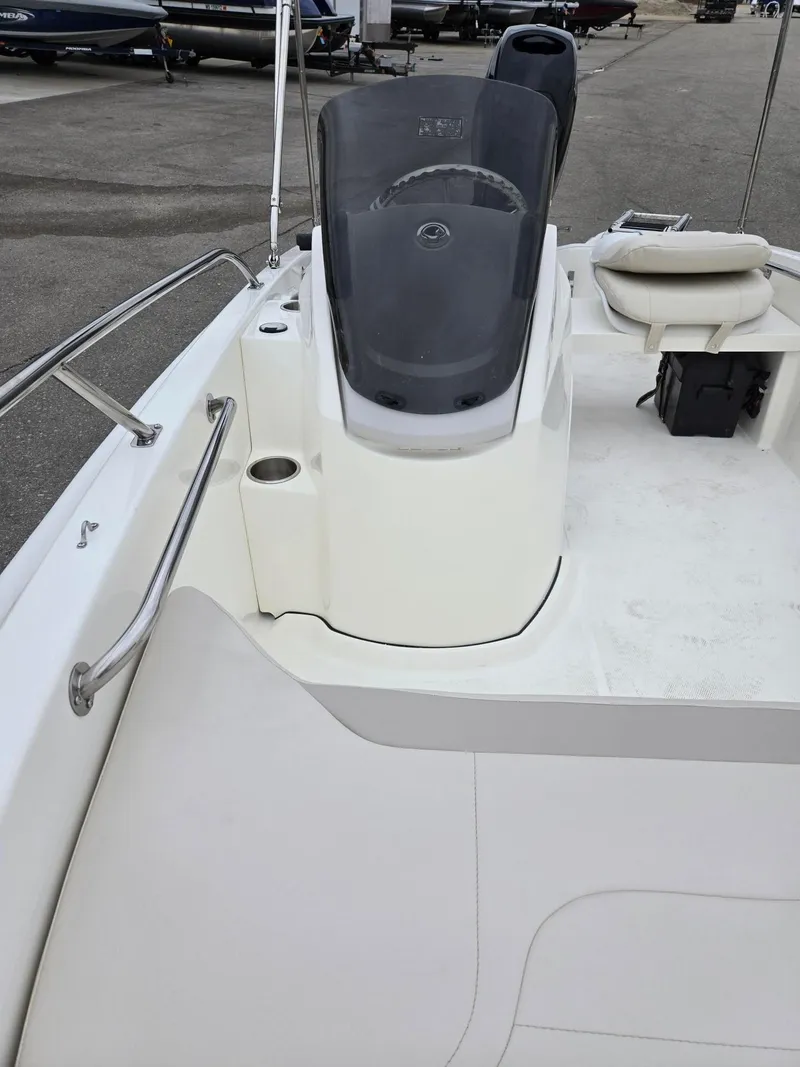 Slide: The Image of 2025 Boston Whaler 130 Super Sport interior with steering console and seating. - 8
