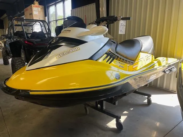 Slide: The Image of 2008 Sea-Doo RXT jet ski in a garage, featuring a yellow and black design. - 3