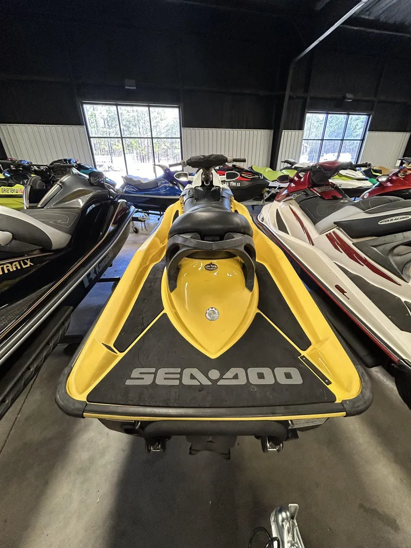 Slide: The Image of 2008 Sea-Doo RXT jet ski in a showroom, yellow and black design. - 4