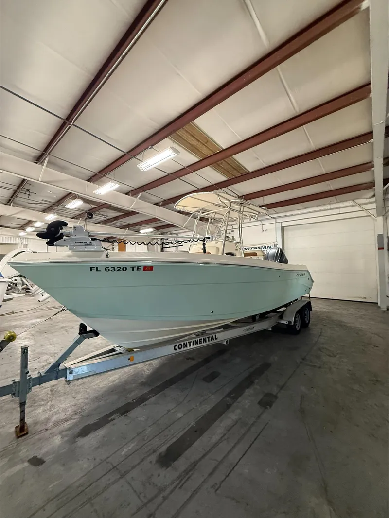 Slide: The Image of 2022 Cobia 237 CC boat on trailer in indoor storage facility. - 1