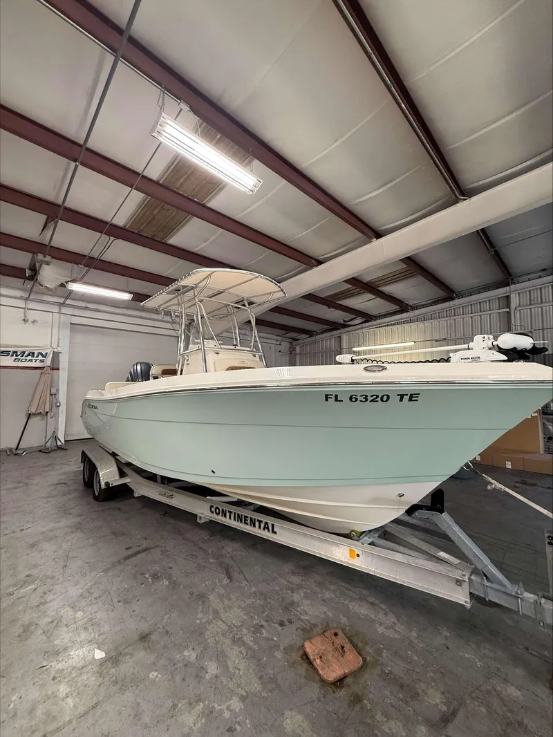 Slide: The Image of 2022 Cobia 237 CC boat on trailer in indoor storage facility. - 3
