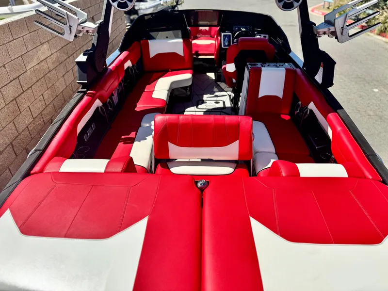 Slide: The Image of 2021 Malibu Wakesetter 25 LSV interior with red and white seating, showcasing spacious design. - 13