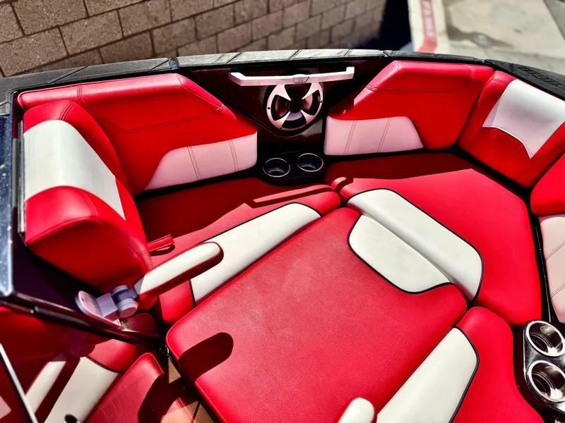 Slide: The Image of Red and white interior of 2021 Malibu Wakesetter 25 LSV boat, featuring comfortable seating. - 16