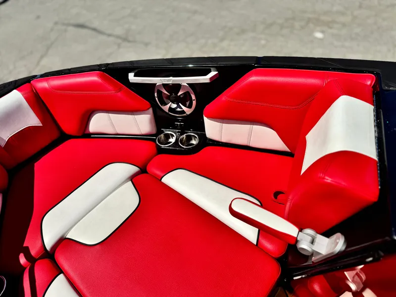Slide: The Image of Red and white interior of 2021 Malibu Wakesetter 25 LSV boat with cup holders and speaker. - 17