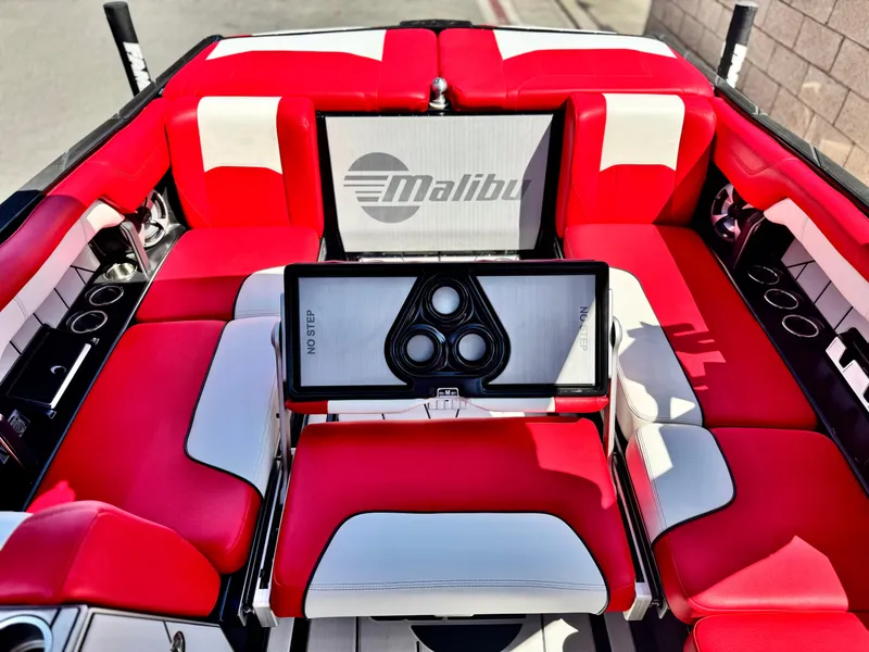 Slide: The Image of 2021 Malibu Wakesetter 25 LSV interior with red and white seating, featuring premium sound system. - 28