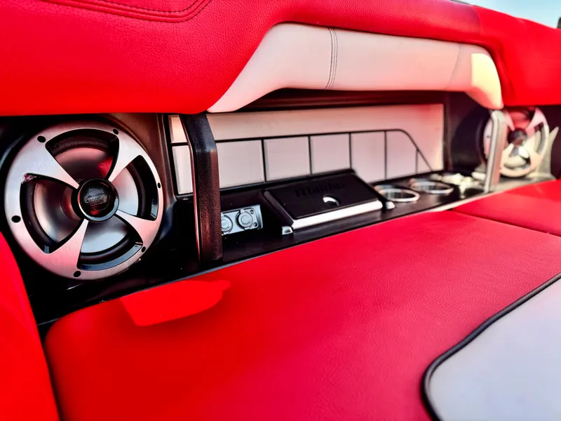Slide: The Image of 2021 Malibu Wakesetter 25 LSV interior with red upholstery and premium audio system. - 29