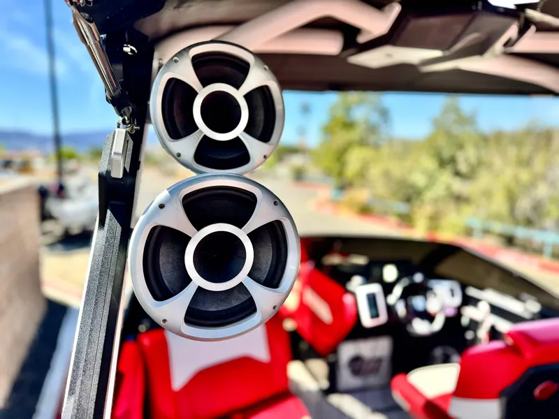 Slide: The Image of 2021 Malibu Wakesetter 25 LSV boat interior with speakers and red seating. - 34